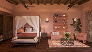 a bedroom with a canopy bed and a couch at Aria Santa Maria in Santo Domingo