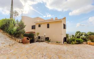 a house with a stone driveway in front of it at Resitour - Kamares Village in Paphos