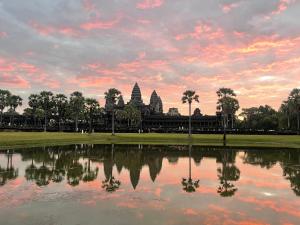 a view of a pond in front of a temple at Angkor Nature Voyages in Phumi Ta Phul