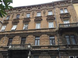 a large brick building with windows and balconies at Apartments Pomerio Rijeka East in Rijeka