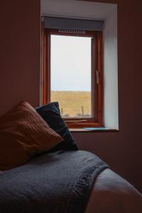 a bed in a room with a window at The Royal Oak in Buxton