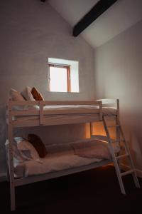 two bunk beds in a room with a window at The Royal Oak in Buxton