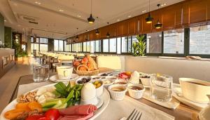 a table with food on it in a restaurant at Solia Hotel in Mezitli
