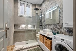 a bathroom with a washing machine and a sink at Baie des Anges in Nice +3 photos
