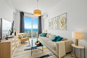 a living room with a couch and a view of the ocean at Baie des Anges in Nice