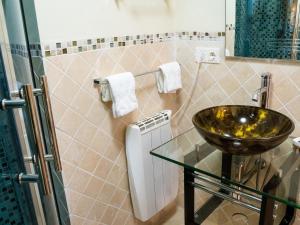 a bathroom with a sink and a glass table at El Rinconcico in Valdelinares +10 photos