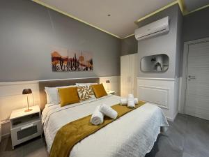 a bedroom with a large bed with towels on it at La Casa dell' Arco in Triggiano