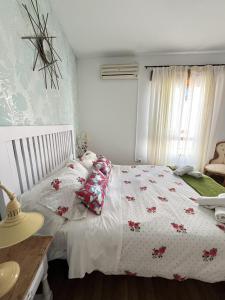 a bedroom with a bed and a table and a window at The Llanete Collection 01 in Martos