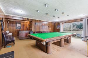 a game room with a pool table and a fireplace at Luxury 5 Bedroom with Pool & Games Room in Potter Street