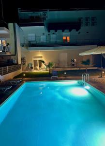 a large blue swimming pool at night at Chroidis Appartment in Sozopoli