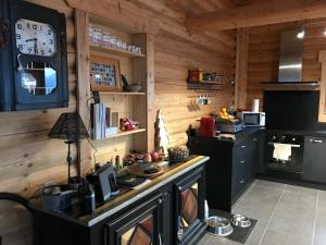 a kitchen with a counter with a clock on the wall at Chalet Cervus in Font-Romeu-Odeillo-Via