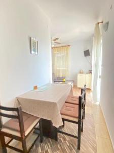 a table and chairs in a living room with a table and a table at Mia 6 in Crikvenica
