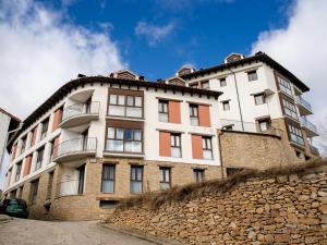 a building on top of a stone wall at El Rinconcico in Valdelinares