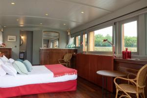 a bedroom with a bed and a desk in a room at Relais de Chambord, a Small Luxury Hotels of the World in Chambord +48 photos