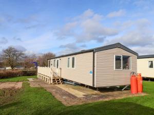a tiny house is parked in a yard at Caravan B14 Beechrise in Filey