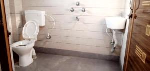 a bathroom with a toilet and a sink at Mayapur in mayapur