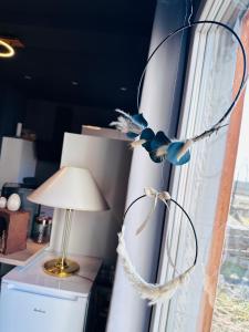 une lampe à côté d'une fenêtre avec un rideau dans l'établissement Tiny House, à Tüttleben 15 autres photos