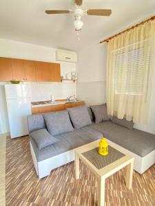 a living room with a couch and a table at Mia 6 in Crikvenica