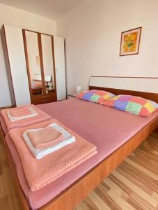 a large bed with two towels on top of it at Mia 6 in Crikvenica