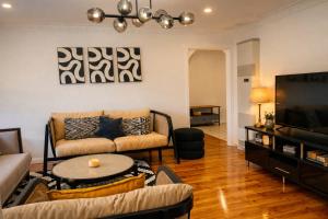 a living room with a couch and a tv at D142 Sunshine Designed Living in Sunshine