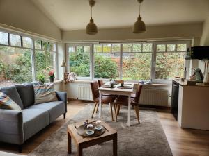 a living room with a couch and a table at B&B 't Greefsch Geluck in Kalmthout