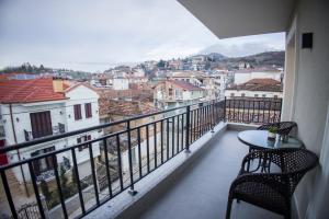 a balcony with a table and chairs and a view at Solen Suites in Korçë
