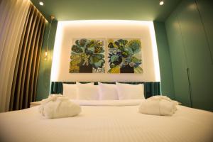 a bedroom with a bed with two towels on it at Solen Suites in Korçë