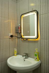 a bathroom with a sink and a mirror on the wall at Nyumbani 2 studio in Dar es Salaam +42 photos