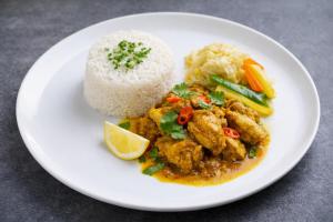 a plate of food with rice and chicken and vegetables at Irie Bamboo in Bamboo +12 photos