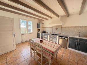 a kitchen with a table with chairs and a sink at Victoria House pool garden in Fourques