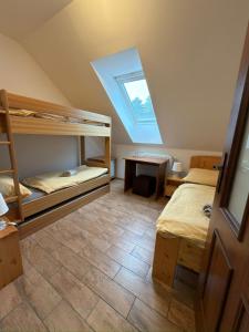 a bedroom with two bunk beds and a skylight at Pod Břesteckou skalou in Břestek