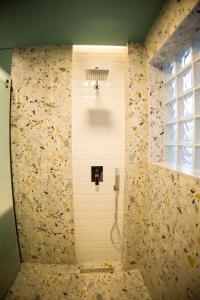 a shower stall in a bathroom with a window at Solen Suites in Korçë +15 photos