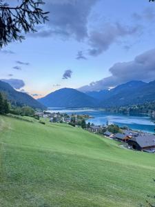 a view of a town with a lake and mountains at Haus Caré in Weissensee