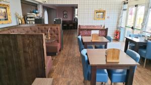a restaurant with tables and chairs and a counter at Chieftain Hotel in Inverness