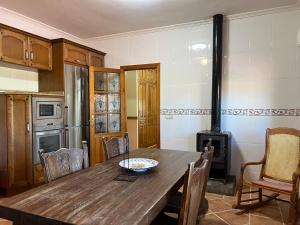 a kitchen with a wooden table and a stove at Casablanca in Candeleda +83 photos