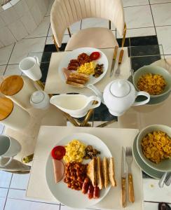 a table with plates of breakfast food on it at Euphoria Escape in Midrand