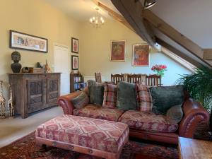 a living room with a couch and a table at Moorgarth Hall Apartment, Ingleton, Yorkshire Dales in Ingleton