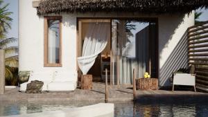 a villa with a pool in front of a house at Eden Island in Agia Paraskevi