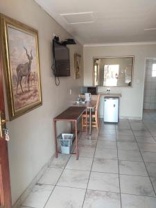 a kitchen with a table and a dining room at Claypot Guesthouse in Northam