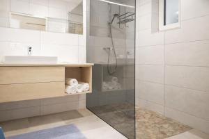 a bathroom with a shower and a sink at Alpinum Residence Lungau Ferienwohnung mit Garten in Tamsweg +44 photos