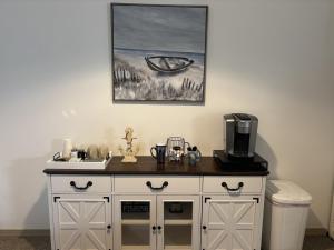 a white cabinet with a coffee maker on top of it at Branson Lakeside Getaway in Branson