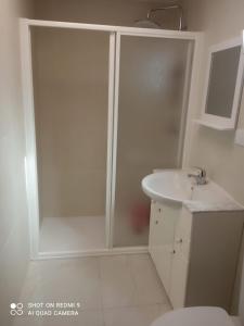 a white bathroom with a shower and a sink at Casa en la huerta - Villa Encarna in Caravaca de la Cruz +19 photos