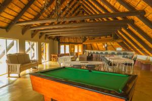 a large room with a pool table in it at Gallery Inn in Bela-Bela