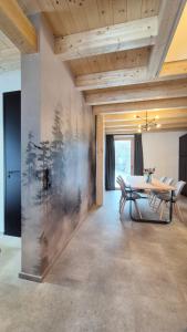a dining room with a table and chairs and a wall at Haus am FELS, Alpenaster in Hermagor +38 photos