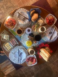 a table with a bunch of food on it at Hostal Art Gallery Chiloè in Castro +37 photos