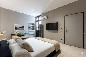 a bedroom with a large bed and a flat screen tv at Casa Leon in Mantova