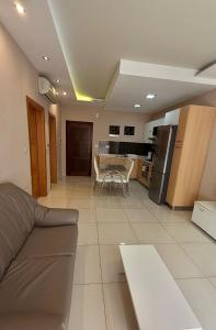 a living room and kitchen with a couch and a table at Oasis Apartment in Sliema