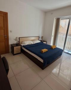 a bedroom with a bed with two towels on it at Oasis Apartment in Sliema