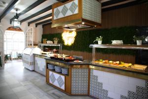 a restaurant kitchen with a buffet with food on at Brasilia in Chipiona