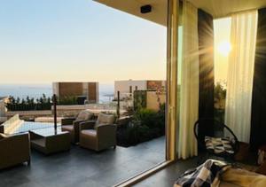 a room with a balcony with a view of the ocean at Vila Mara in Dhërmi